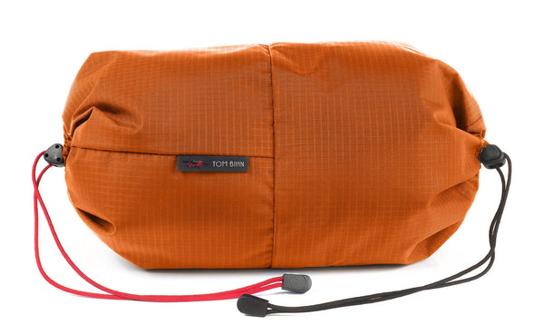 An Aeronaut 30 Travel Laundry Stuff Sack in Persimmon Cerylon.